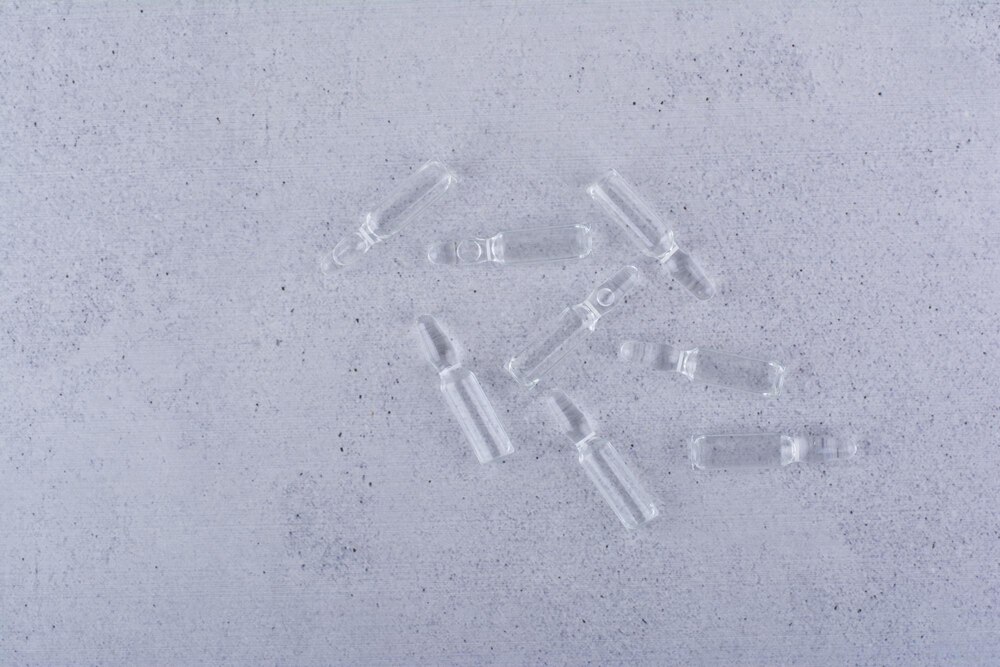 Medical ampoules standing on marble background. High quality photo