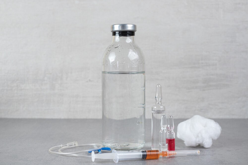 Medical ethanol with cotton wool and syringe