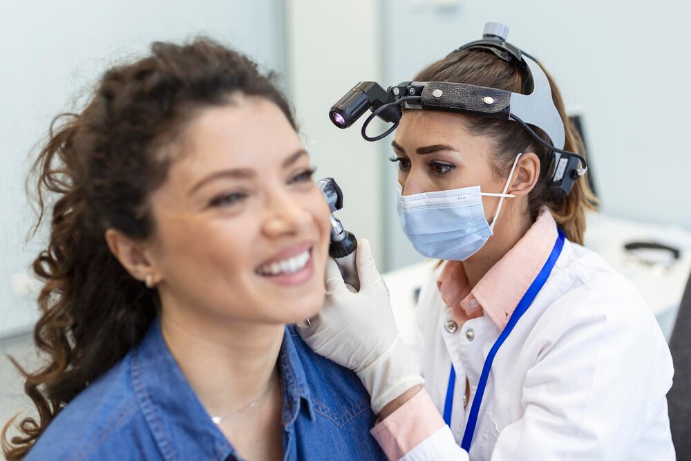 Hearing exam Otolaryngologist doctor checking woman's ear using otoscope or auriscope at medical clinic